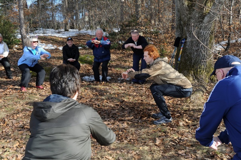 A group of people outside in the woods

Description automatically generated